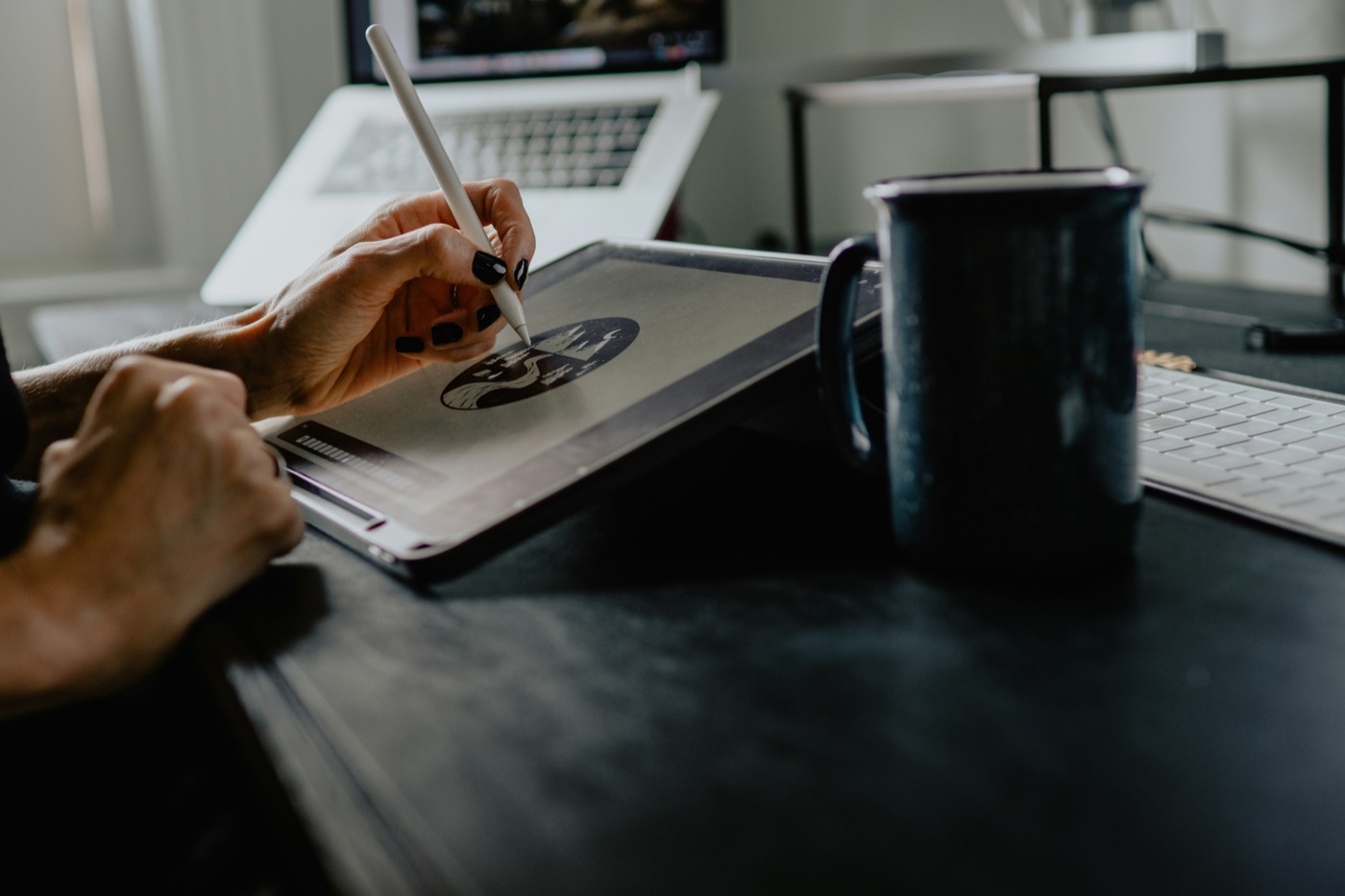 An artist drawing at a desk